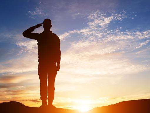 saluting soldier at sunset