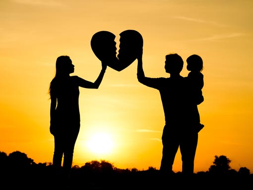 silhouette of couple holding up a broken heart