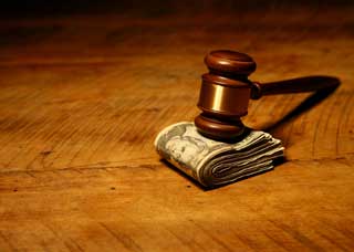 law-packages-mss-gavel gavel on top of pile of cash on table